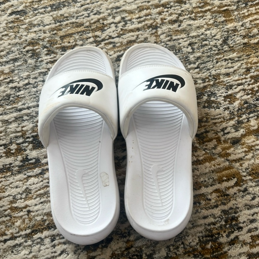 White Nike slides woman’s size 9.